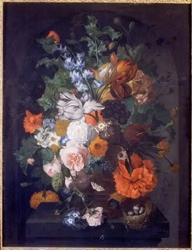 Flowers on a stone ledge with a bird's nest