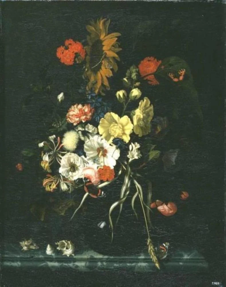 Flowers with a sunflower in a glass vase with shells