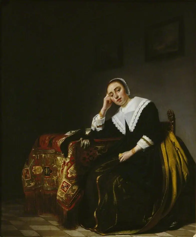 A Woman seated beside a Table