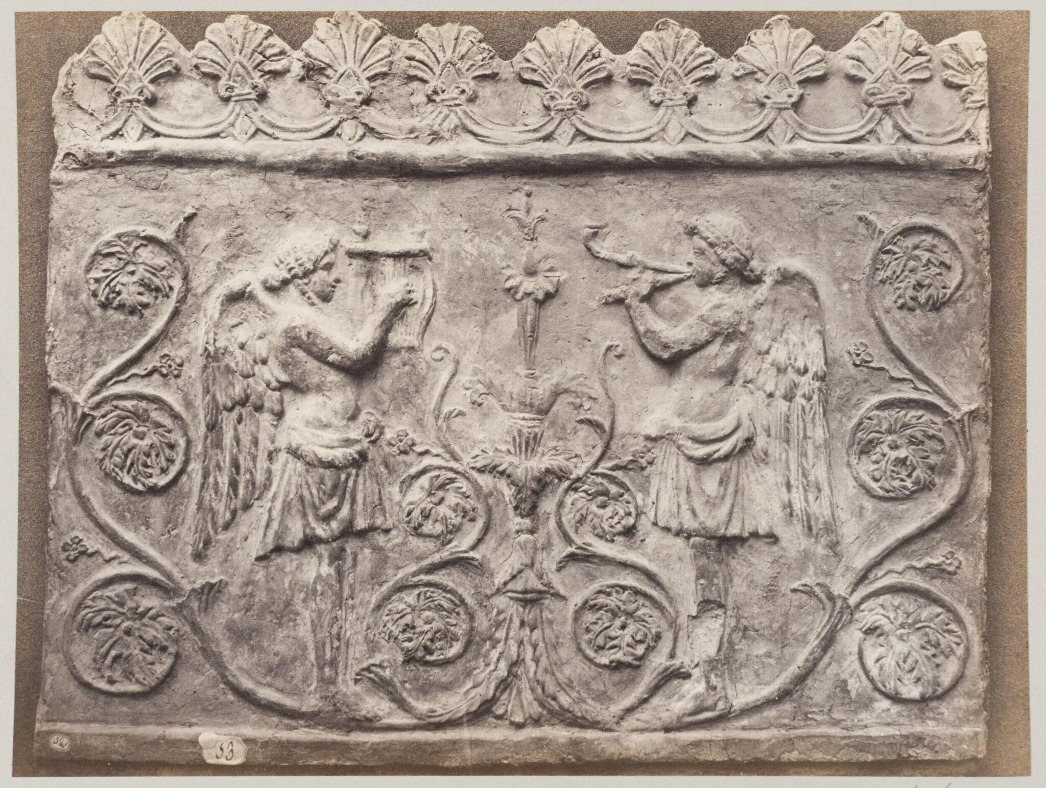 Bas-relief portion of frieze of Genii with double flutes and lyre, by Louise Laffon, photographic, 1864