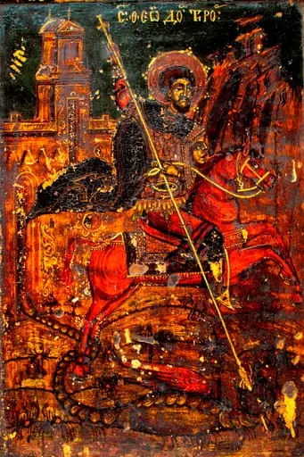 Sfântul Sfântul Teodor Tiron călare pe un cal roșu, omorând balaurul.Redat ca sfânt militar, cizme înalte, tunică 3/4 roșie, lorica scurtă, mantie bleumarin fluturând în vânt, pantaloni mulați. Capul descoperit, părul bogat,ondulat, scurt, castanii, expresia chipului sobră. Nimb mărginit de o linie galbenă,dublată la exterior de formațiuni punctiforme albe, în formă de floare.Pe scut o figură antropomorfă, în relief. În mână ține o suliță lungă, subțire, cruciformă, cu care omoară balaurul, cu o coadă lungă, încolăcită pe după picoarele calului, aripi mari, deschise, roșii, capul mic. Calul este bine proporționat, coada este înnodată, șaua și harnașamentul decorate fin cu alb. Pe fundal relief muntos,culmi abrupte în partea dreaptă. În cea stângă, sunt pictate zidurile unei biserici înalte. Linia albă, cu care este executat conturul și decorurile stilizate, fitomorfe foarte fină. Fond de culoare albastru verzui, marginea excizată fiind pictată jumătate cu roșu, cealaltă exterioară grena. Inscripția sus.- litere albe, caligrafice și prescurtări. Pictura este întunecată, cu urme de murdărie, fum și mici lacune ale stratului pictural. Pe cantul superior - cui de metal ,vechi. Compoziția este armonioasă, proporțiile respectate, desenul fin, paleta cromatică, dominată de tonuri calde în contrast cu fondul metalizat. De numele Sfântului Teodor este legată sărbătoarea populară a Sântoaderului, ce se ține în prima săptămână a postului Mare(Sâmbăta lui Toader; Tudorusale)
