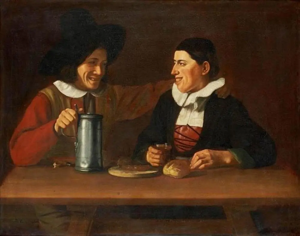 Two grinning men behind a table with a pewter, glass of wine and bread
