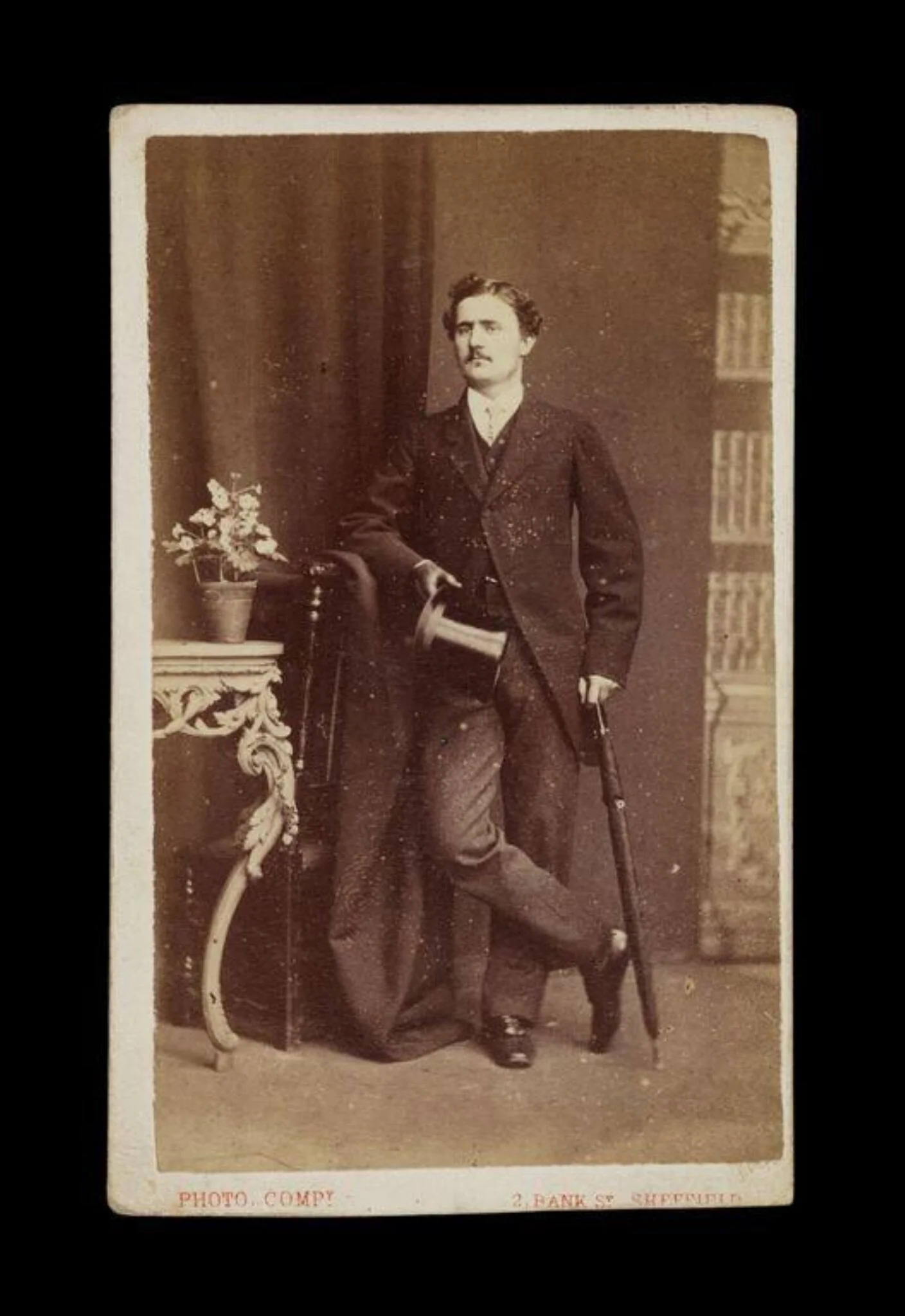 portrait of a man holding an umbrella and top hat, by The Sheffield Photographic Company, photographic, 1850