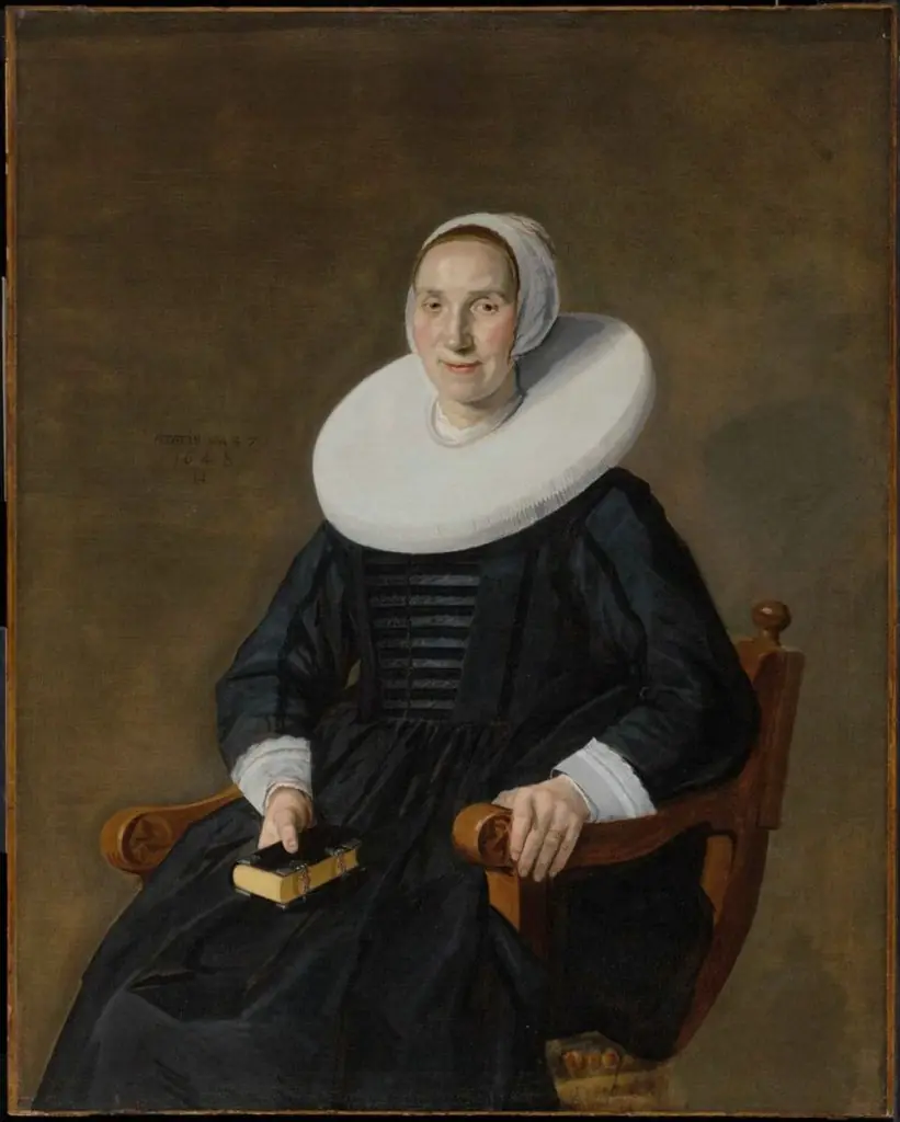 Portrait of a seated woman with a book
