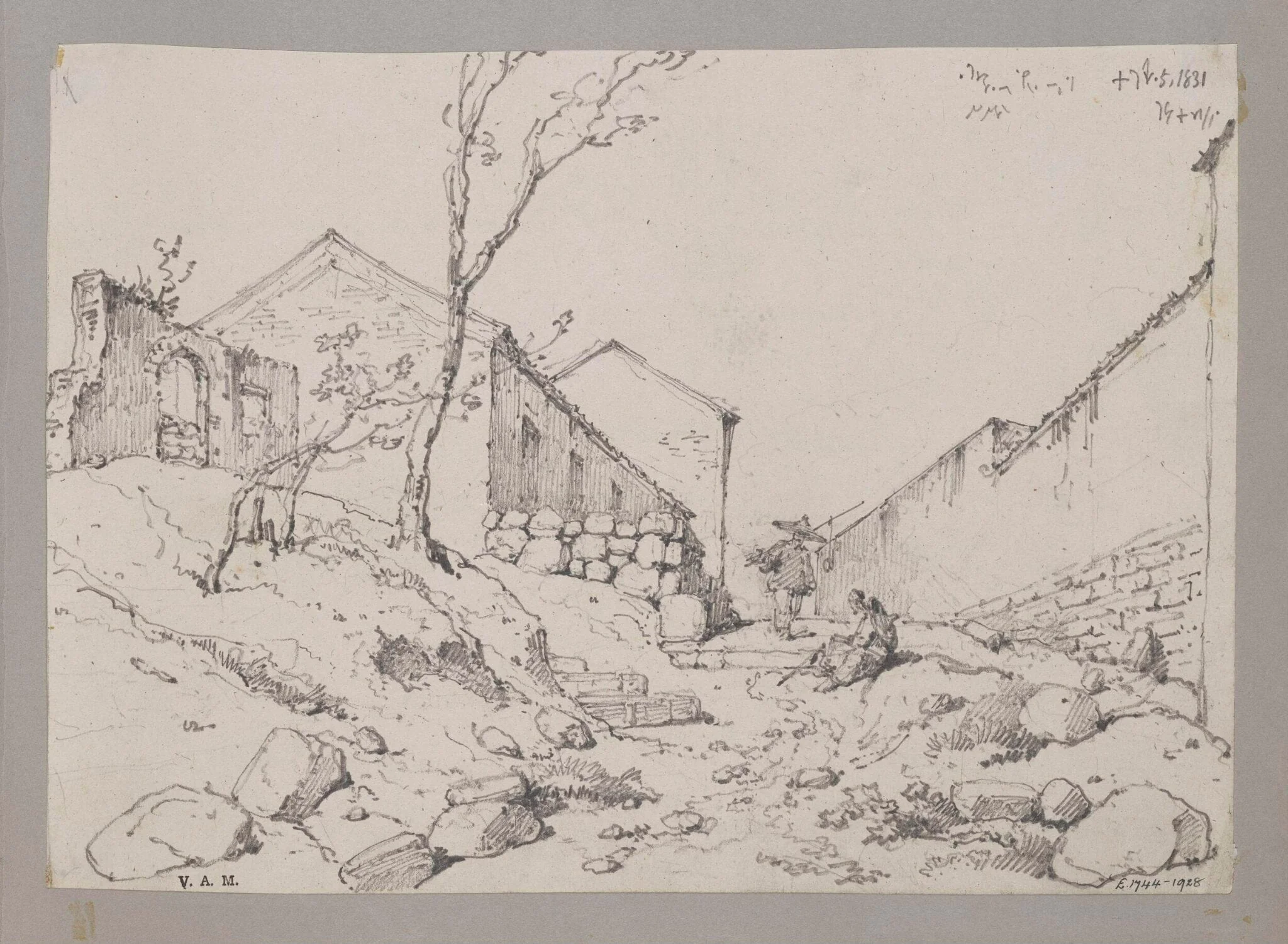 A path leading uphill between houses and a long wall