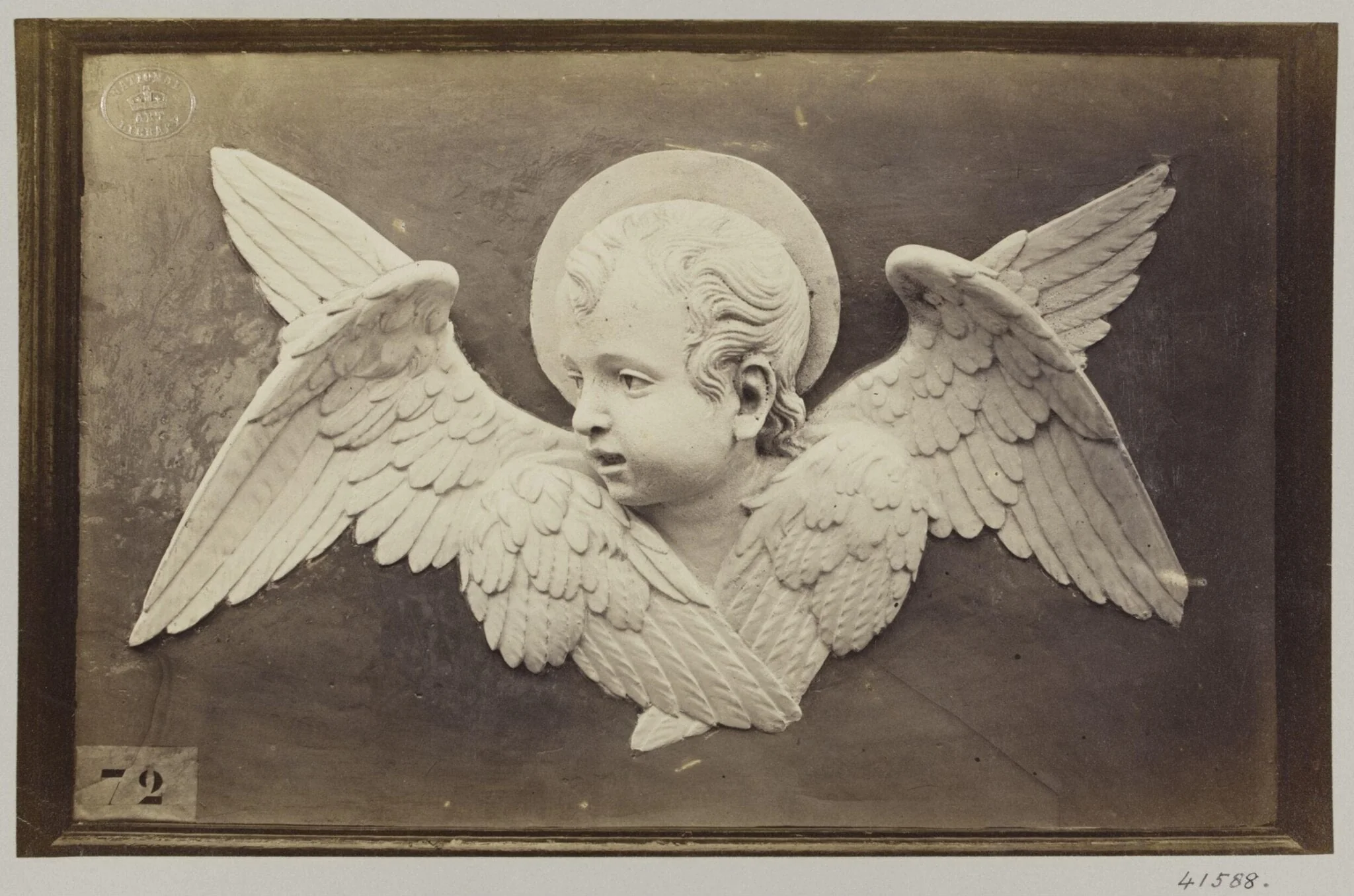 Head of Seraph in glazed earthenware