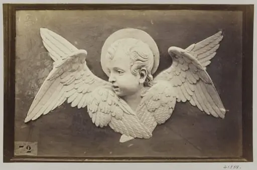 Head of Seraph in glazed earthenware