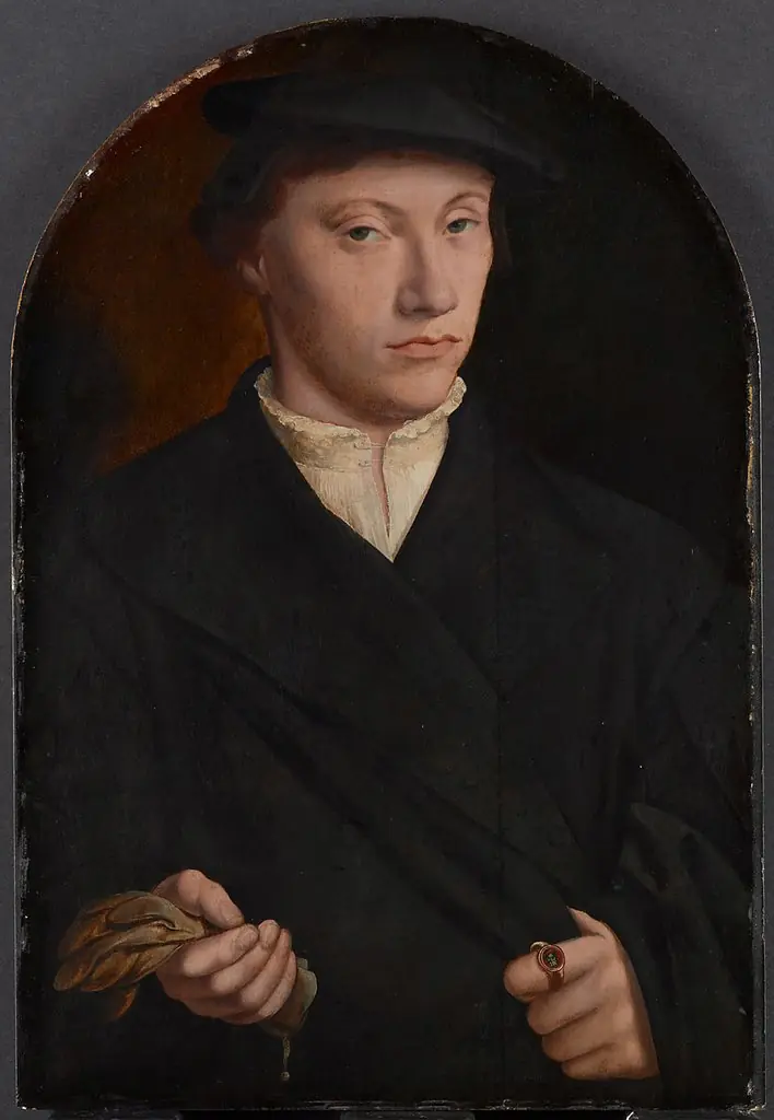 Portrait of a young man holding gloves