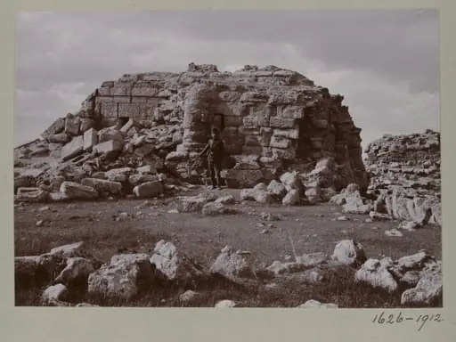 Photograph of a a ruined temple with a Turkish soldier in the Great Iwan at Hatra, Iraq