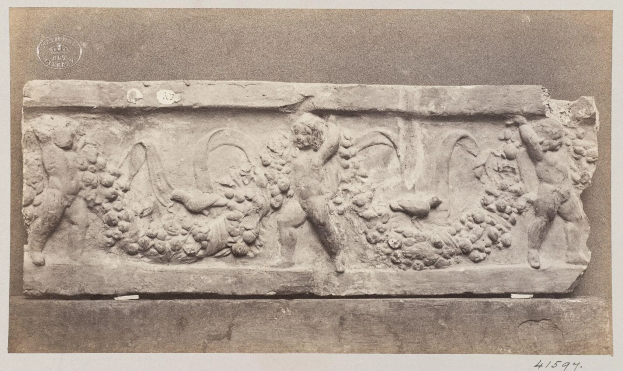 Bas-relief of Cupids with garlands in terra cotta