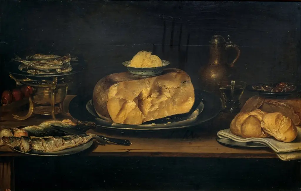 Still life of a table with crockery, cheese, sausage and fish