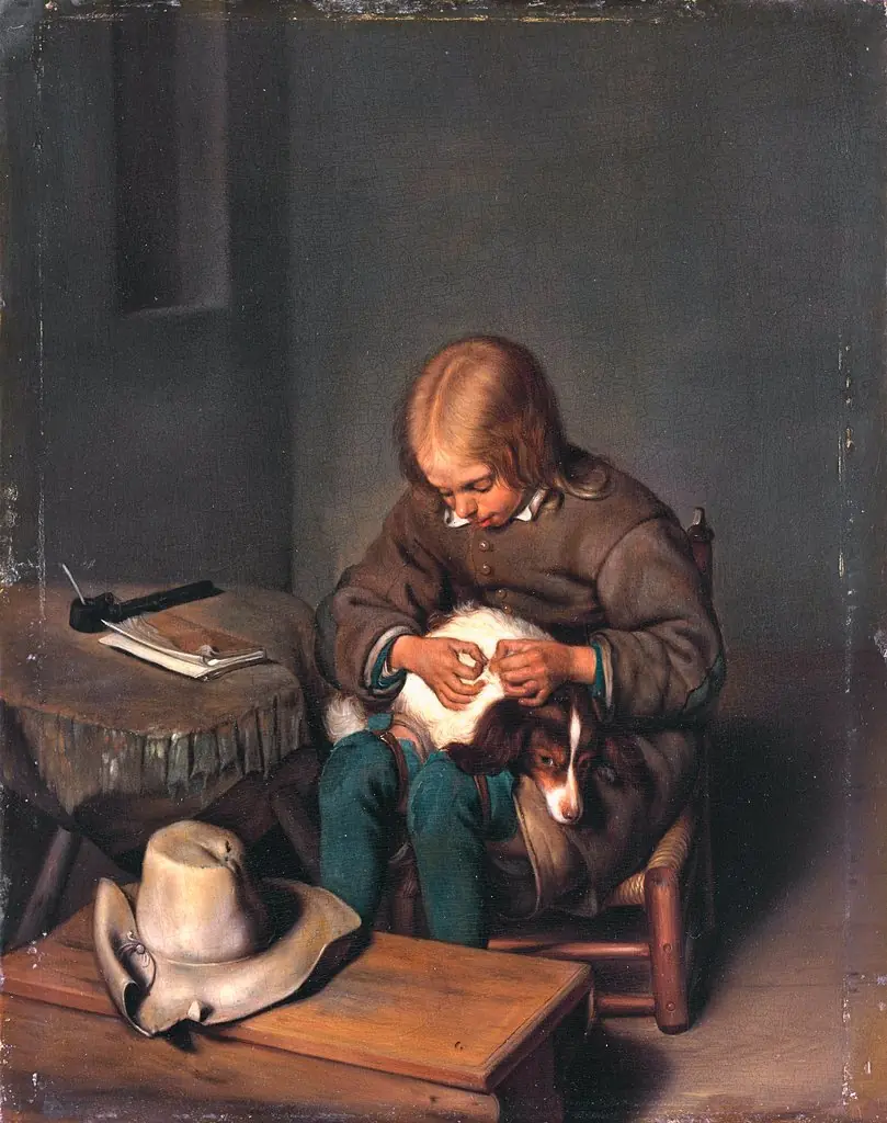 Boy fleaing a dog