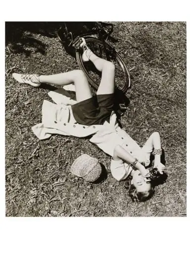 Girl with Camera Lying on Grass