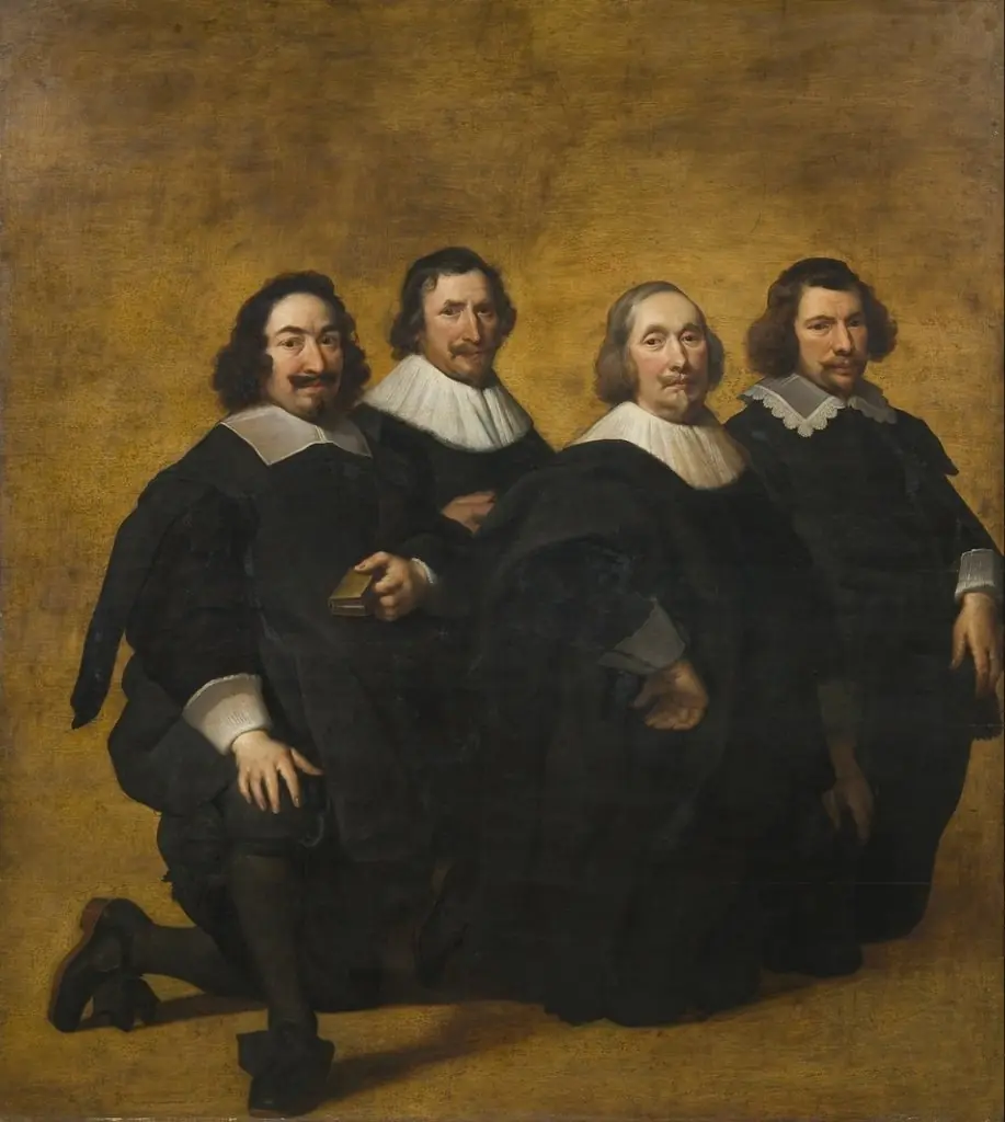 Portrait of four kneeling men