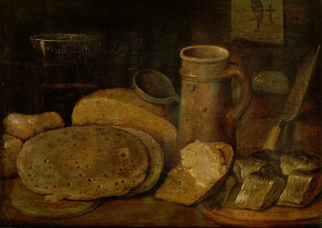 Still life with pottery, herring and pancakes, a print of an owl on the wall