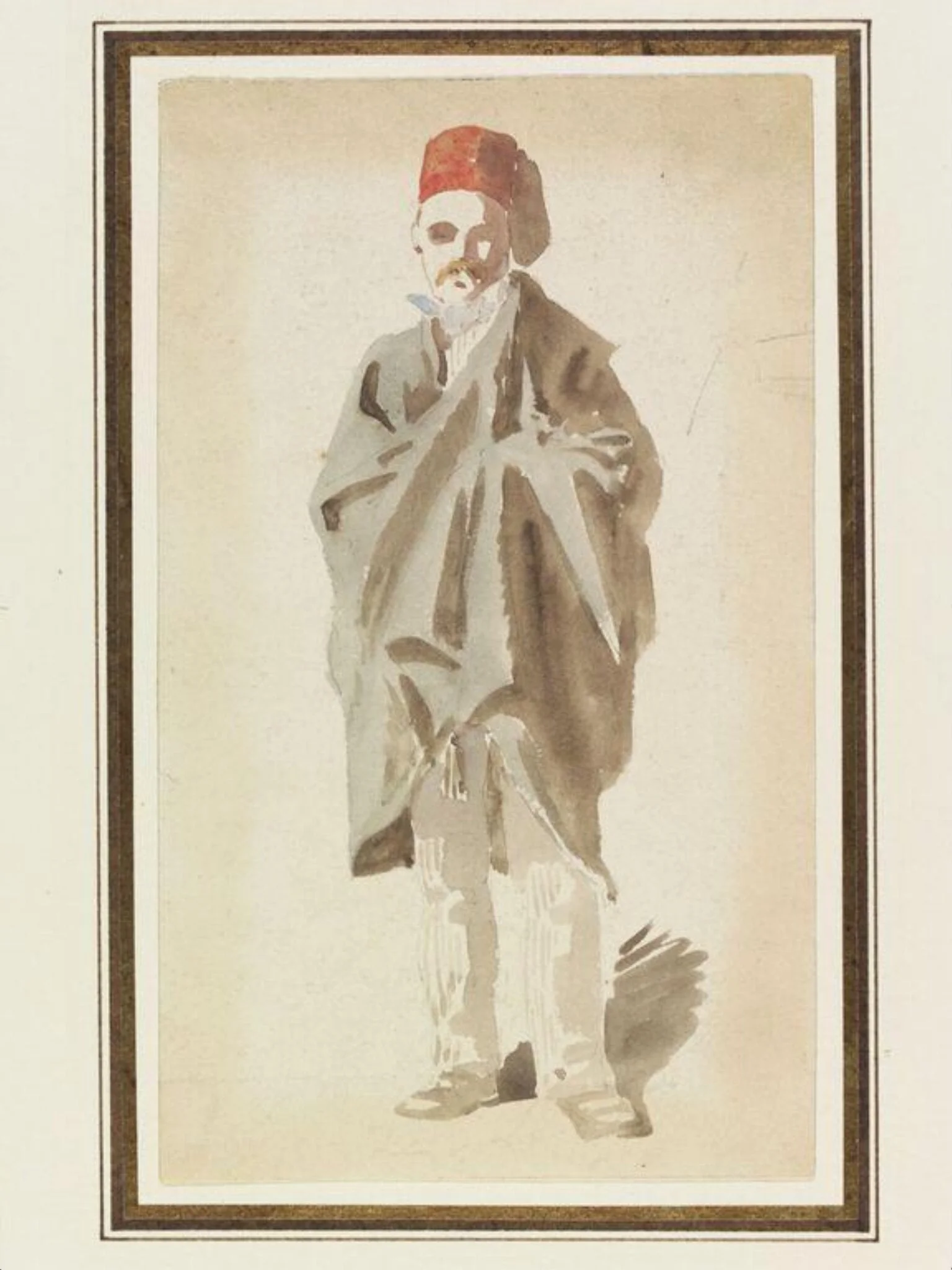 A man wearing a fez and wrapped in a long cloak
