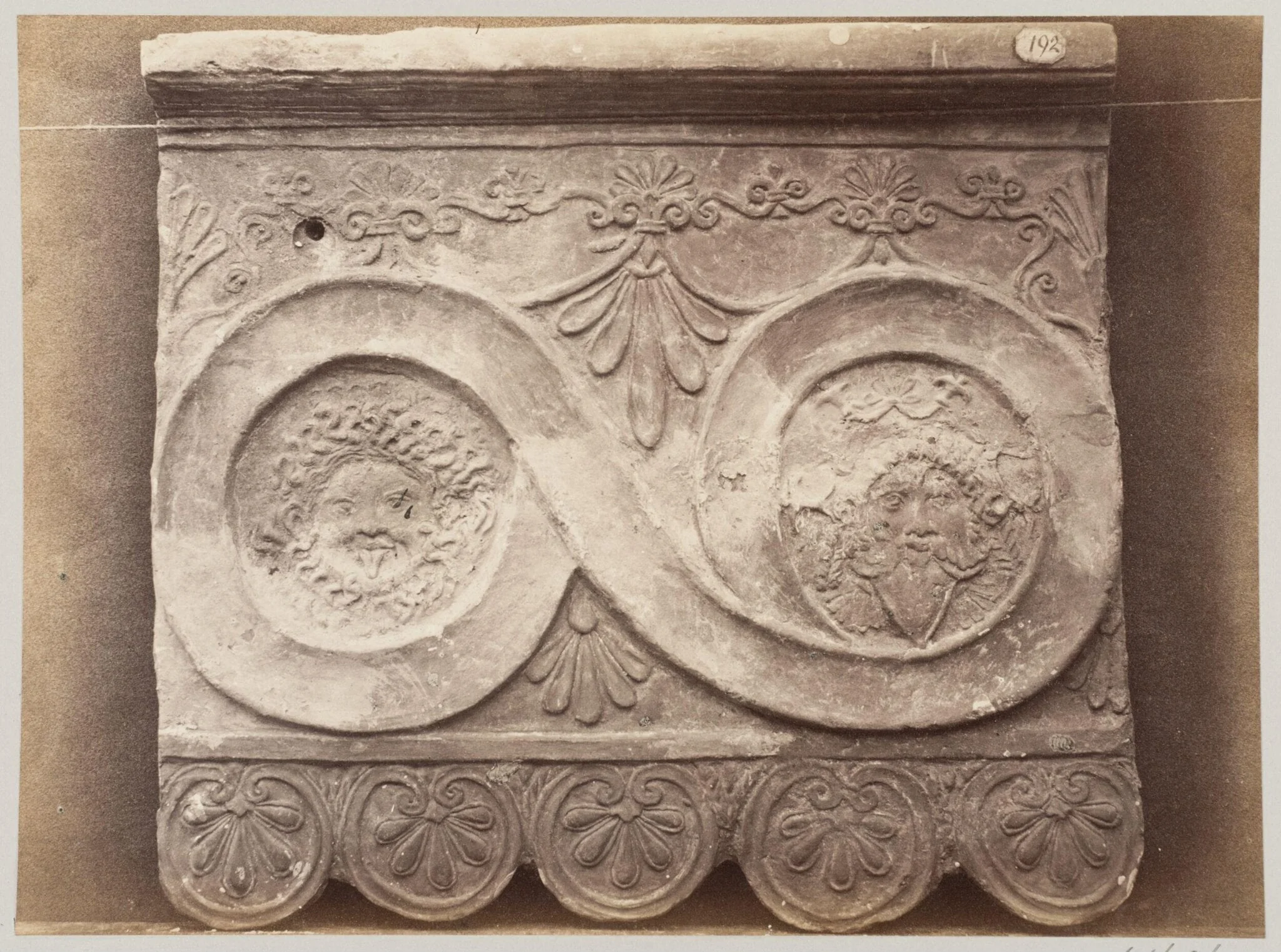 Bas-relief portion of a frieze of scrollwork with masks in terra cotta, by Louise Laffon, photographic, 1864