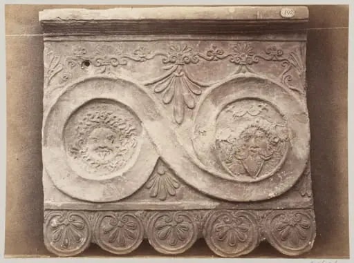 Bas-relief portion of a frieze of scrollwork with masks in terra cotta