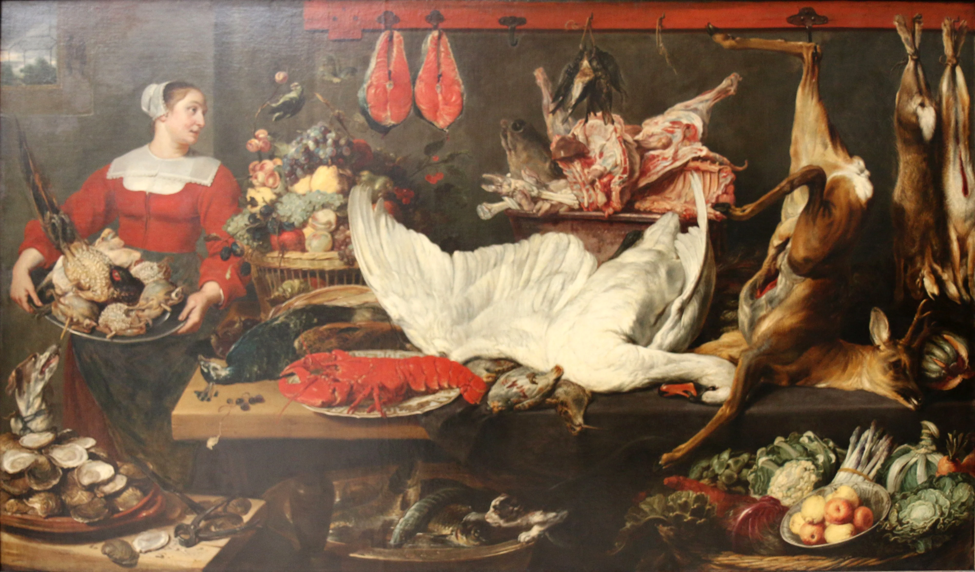 Kitchen interior with a servant girl holding a plate with poultry and a table with an abundance of game, fish, fruit and vegetables