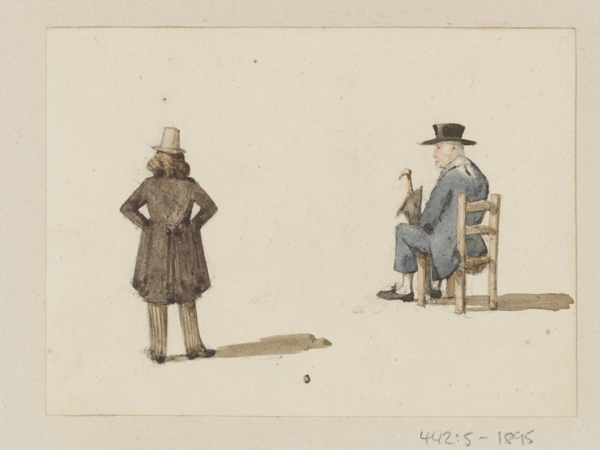 A man standing and another seated
