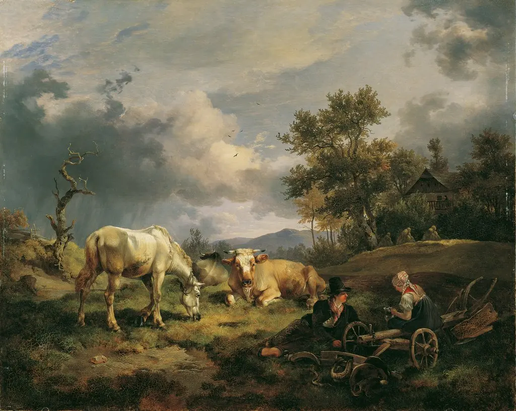 Cow shepherds resting in the meadow next to their cows