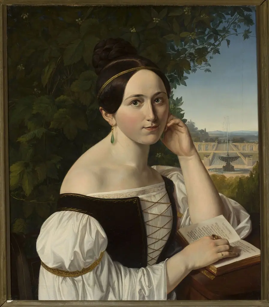 Portrait of a young woman with a book in a park