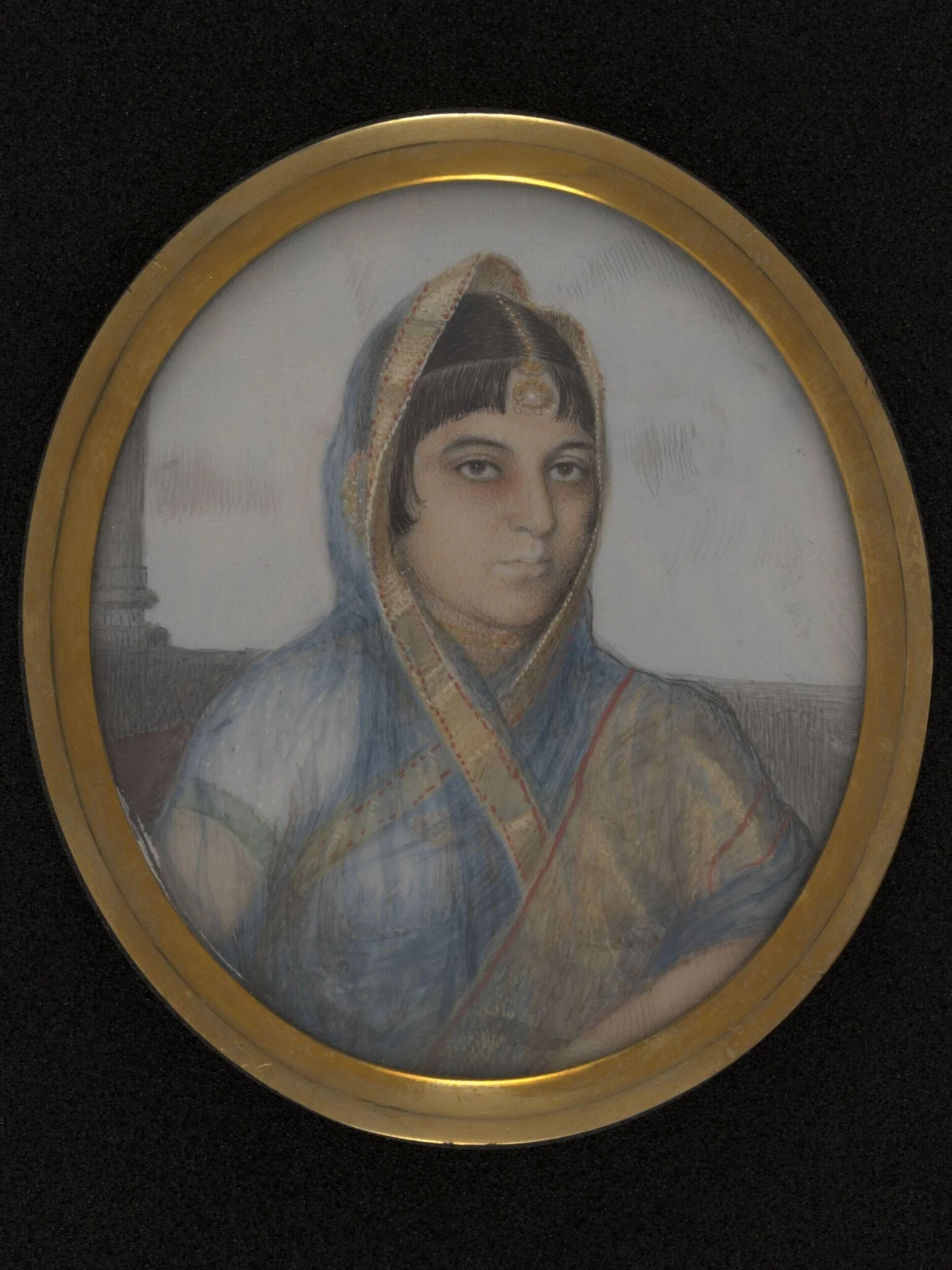 A lady in a blue, gold-edged sari.