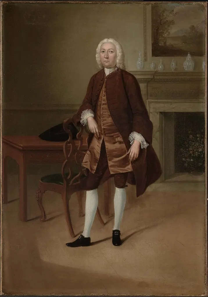 Portrait of a Man Standing Beside a Table