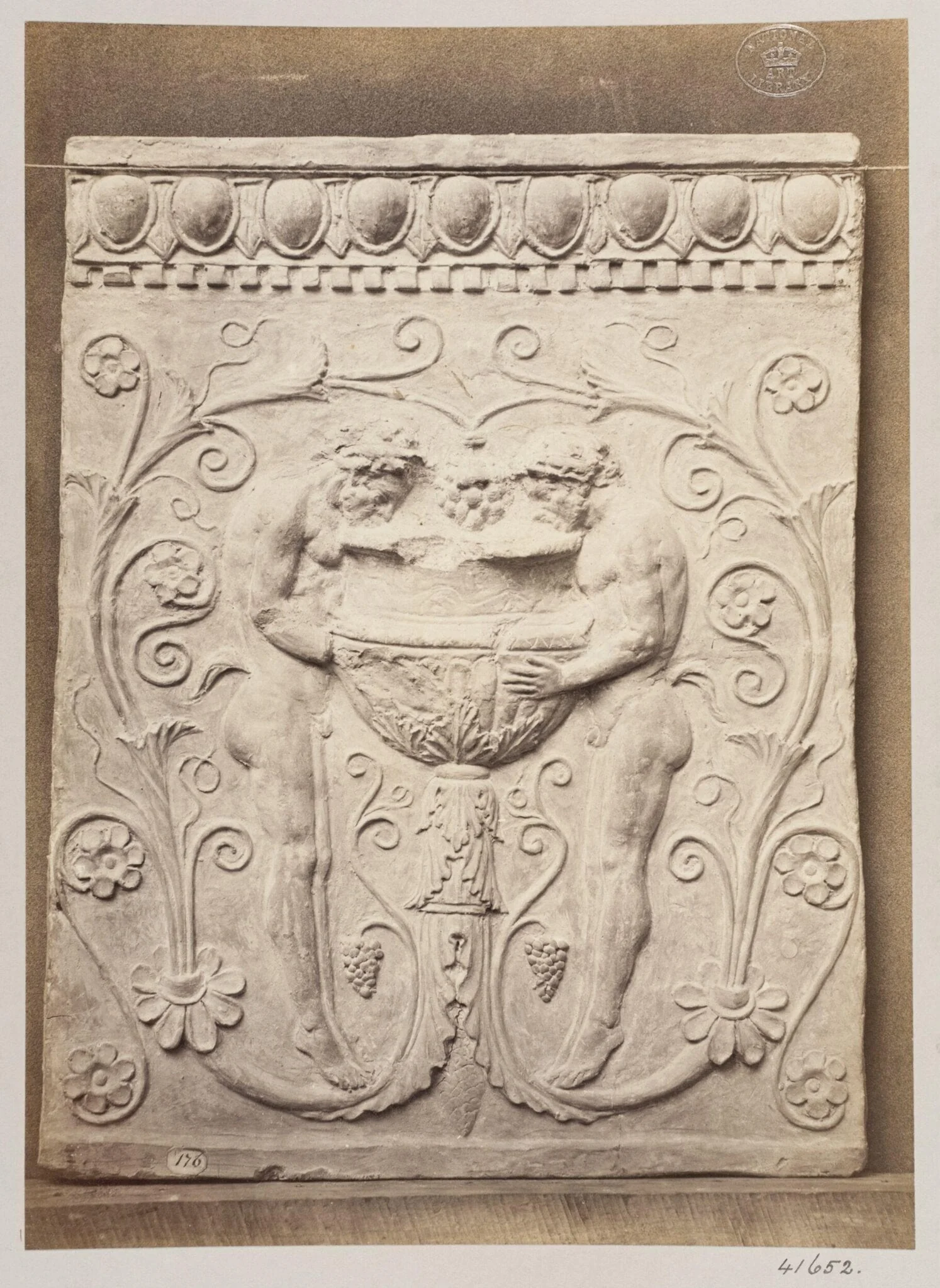 Bas-relief of a portion of a frieze showing two satyrs and a vessel in terra cotta