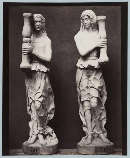 Marble statue of two angels holding torch bearers