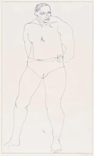 A man standing, with hands behind him
