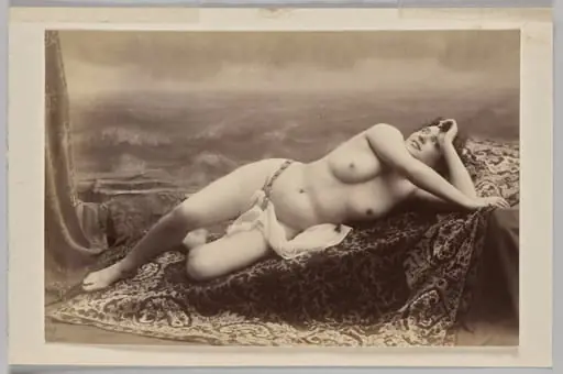 Untitled (reclining nude on carpet against painted backdrop of waves)