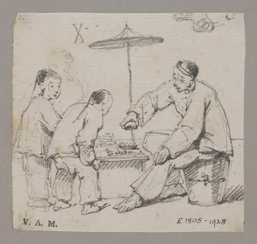 A Chinese man seated at a table, watched by two children