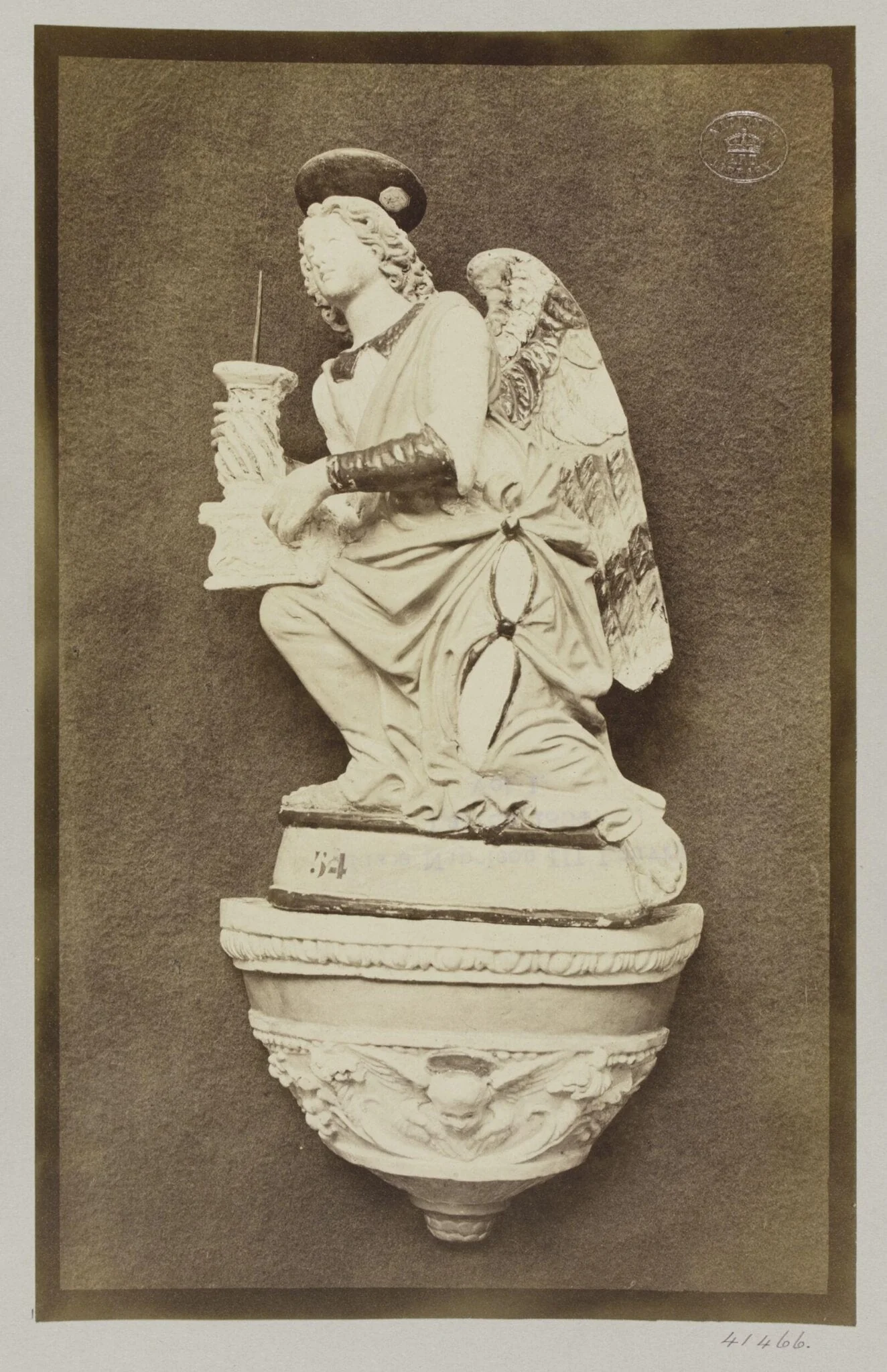 Figure of an Angel holding pricket candlestick by Luca della Robbia Ware