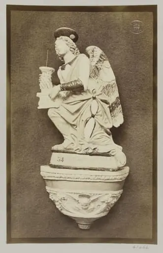 Figure of an Angel holding pricket candlestick by Luca della Robbia Ware