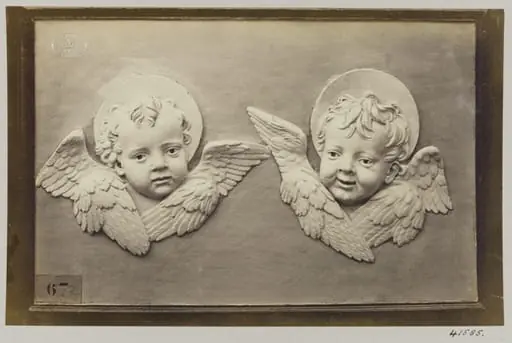 Two enamelled heads of seraphines