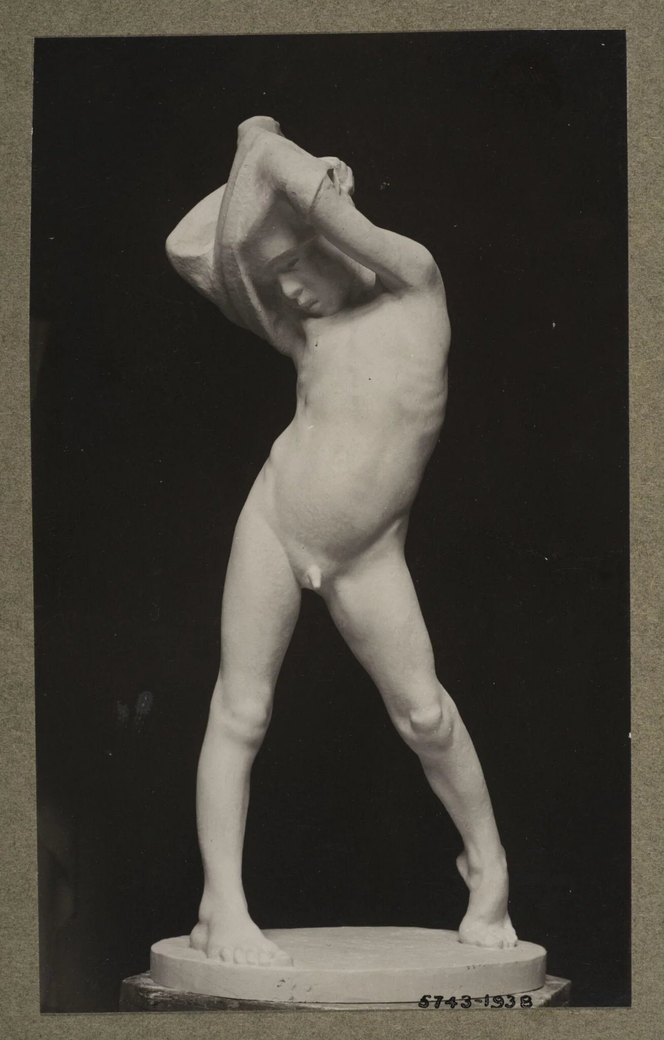 Boy struggling into his shirt, by Ercole Drei, photographic