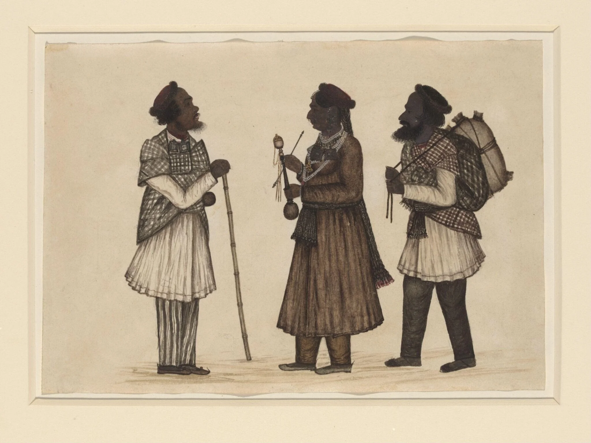 A Punjabi woman standing with a Punjabi man on either side.