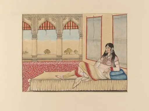 An Indian lady reclining on a couch in the open verandah of a palace.