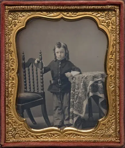 Standing boy with bottle curls