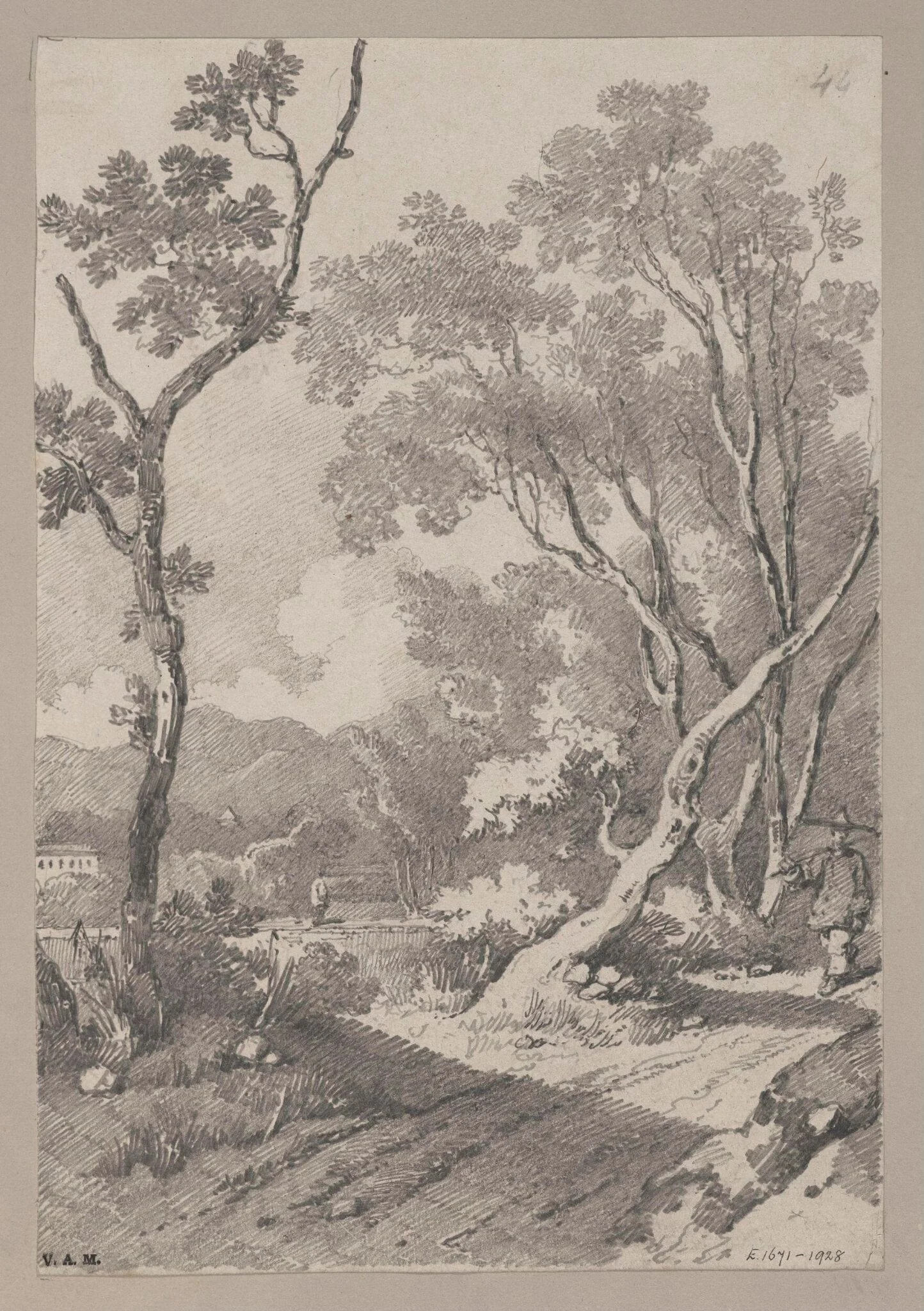 A figure on a path between rocks and trees