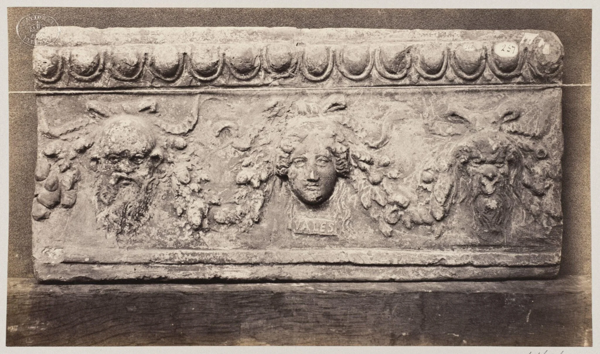 Bas-relief of three baccanalian masques in terra cotta
