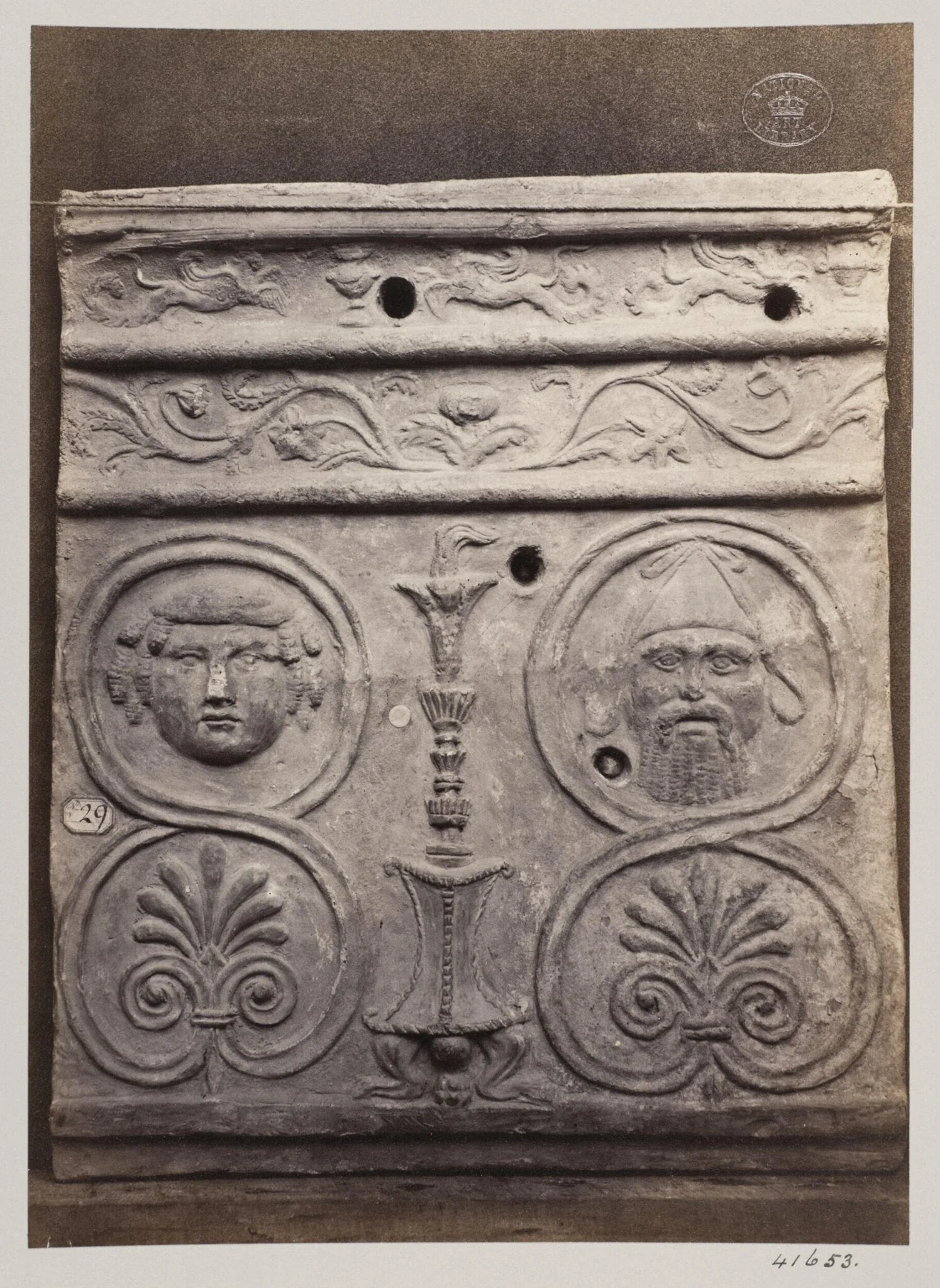 Bas-relief of a portion of a frieze of a thymiaterion and bacanallian masks in terra cotta