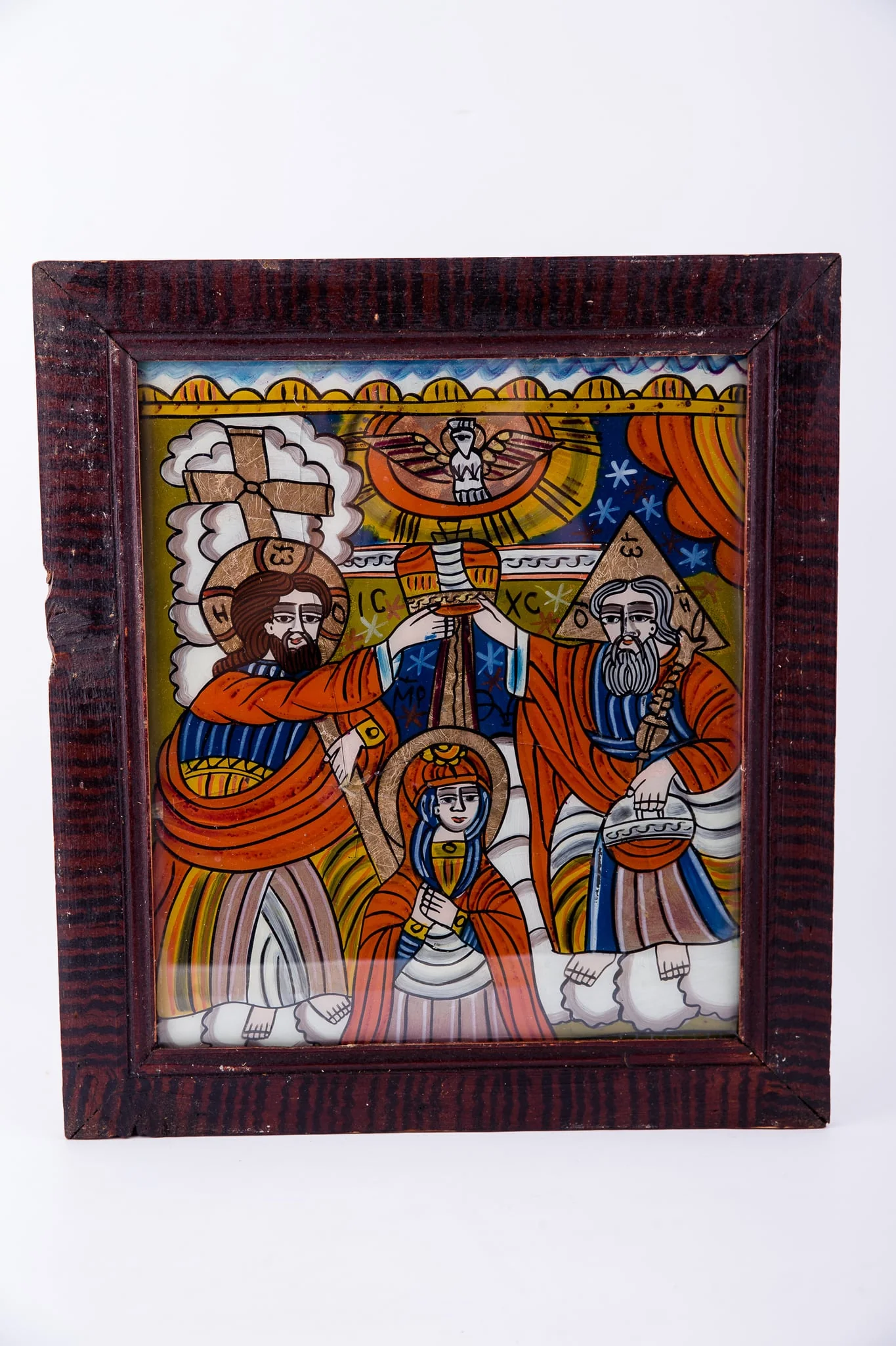 Dumnezeu Tatăl, Fiul Iisus Hristos așează dimpreună coroana de împărăteasă pe capul Maicii Domnului, iar din cerurile deschise se pogoară Sfântul Duh, printr-un porumbel, pe o rază luminoasă de soare. Compoziția se împarte simetric și echilibrat în patru părți, asemenea unei cruci. Fiul - Tatăl; Sfântul Duh - Maica Domnului. Maica Domnului are înălțimea mică a unei fetițe, fiind aleasă dintre oameni. Dumnezeu-Fiul are în mâna dreaptă Crucea, iar Dumnezeu-Tatăl are globul pământesc. Maica Domnului are mâinile împreunate în rugăciune și ascultare, smerenie și primire de bunăvoie. Sunt înveșmântați în roșu vermillon-galben-albastru. În registrul îndepărtat superior este cerul albastru cu stele albe, iar în registrul inferior sunt nori albi, toată narațiunea desfășurându-se în Împărăția Cerurilor, Maica Domnului fiind ridicată de pe pământ - Adormirea Maicii Domnului. În registrul superior, tematica iconografică este încadrată de un segment decorativ, geometrizant, asemenea unor colțișori de dantelărie. Inscripția în chirilică se traduce ICXC MP Iisus Hristos Maica Domnului. Cromatică: roșu vermillon, galben, albastru, alb. Icoana ste din Țara Oltului, Șcheii Brașovului.