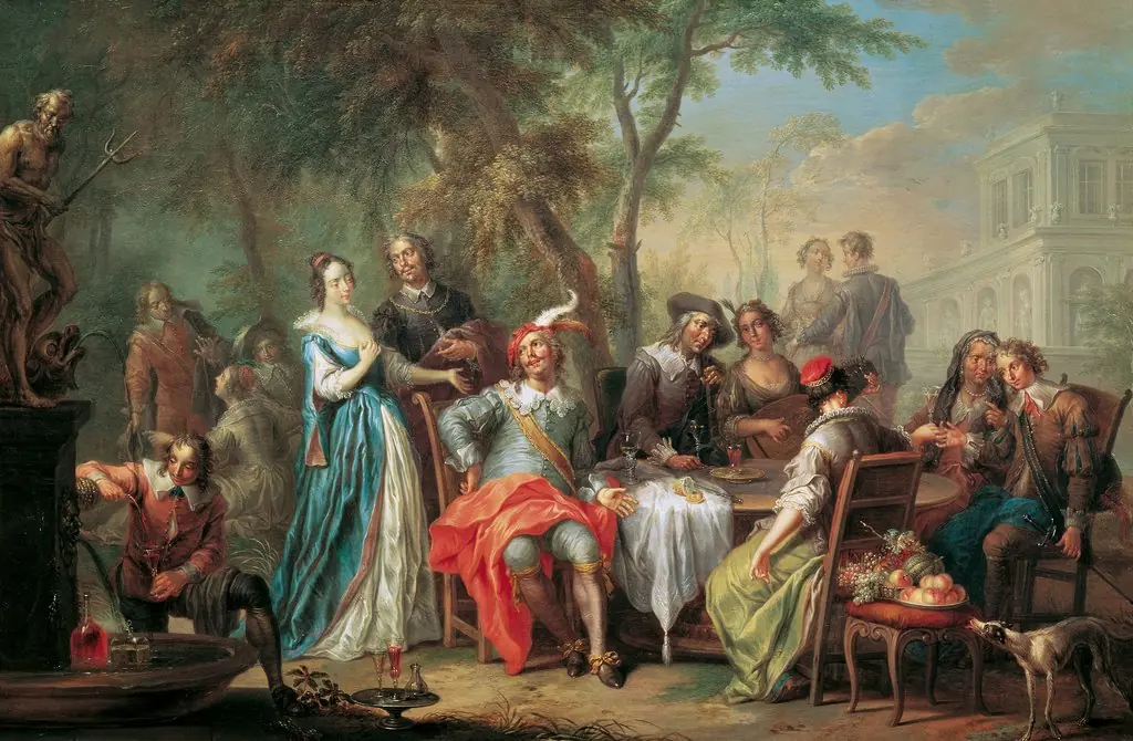 Elegant company supping in a park