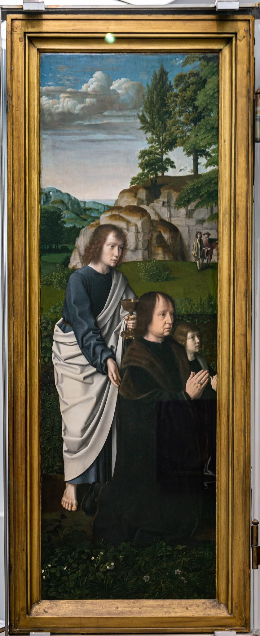 De H. Johannes de Evangelist met  Jan de Trompes en zijn zoon, by Gerard David, oil, 1505