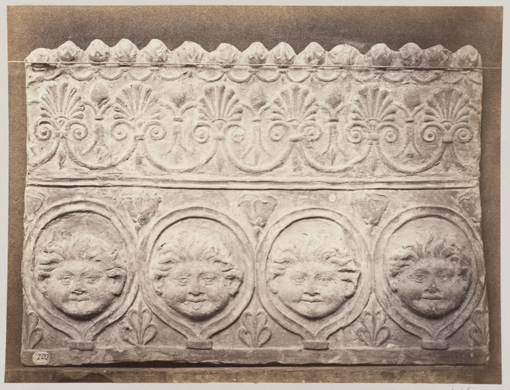 Bas-relief portion of a frieze of four masked young satyrs in terra cotta, by Louise Laffon, photographic, 1864