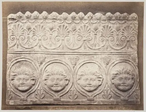 Bas-relief portion of a frieze of four masked young satyrs in terra cotta