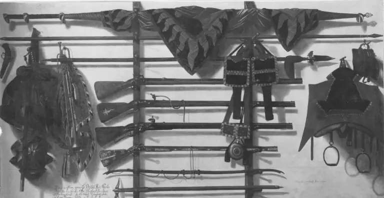 Trompe l'oeil of a wooden rifle rack, a regimental banner, two single-barrelled rifles, a Silesian tschinke, horse saddle with tack and other weaponry hanging on a white wall