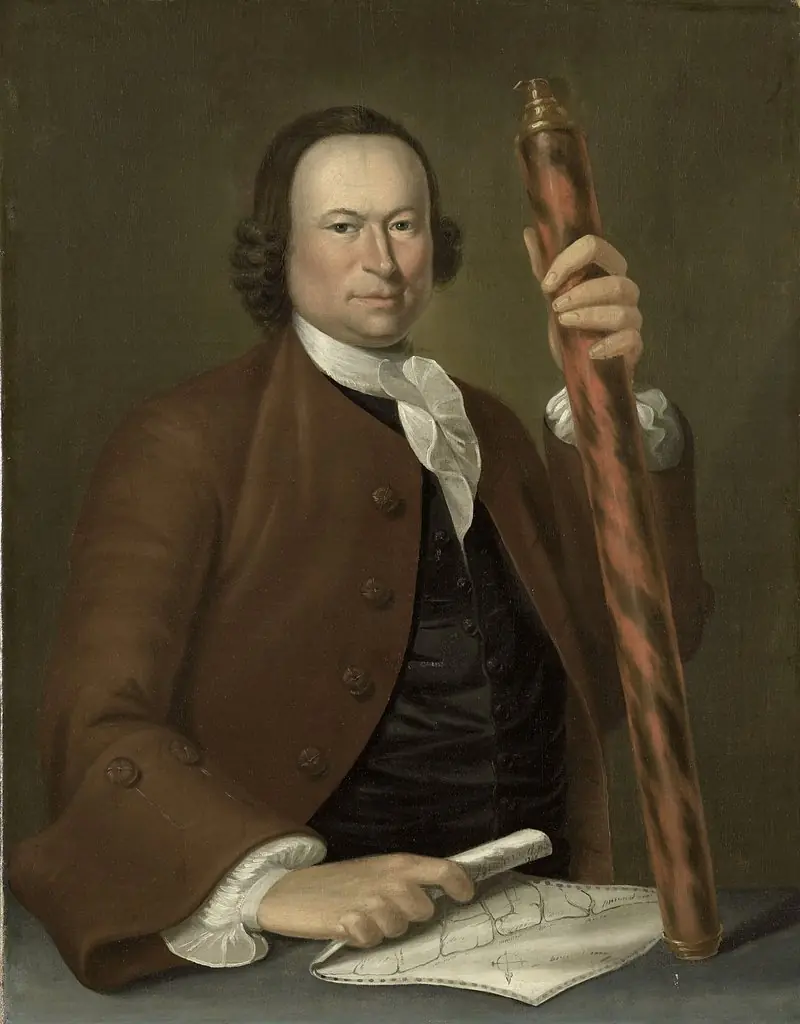 Portrait of an officer at sea with a map and binoculars in hand